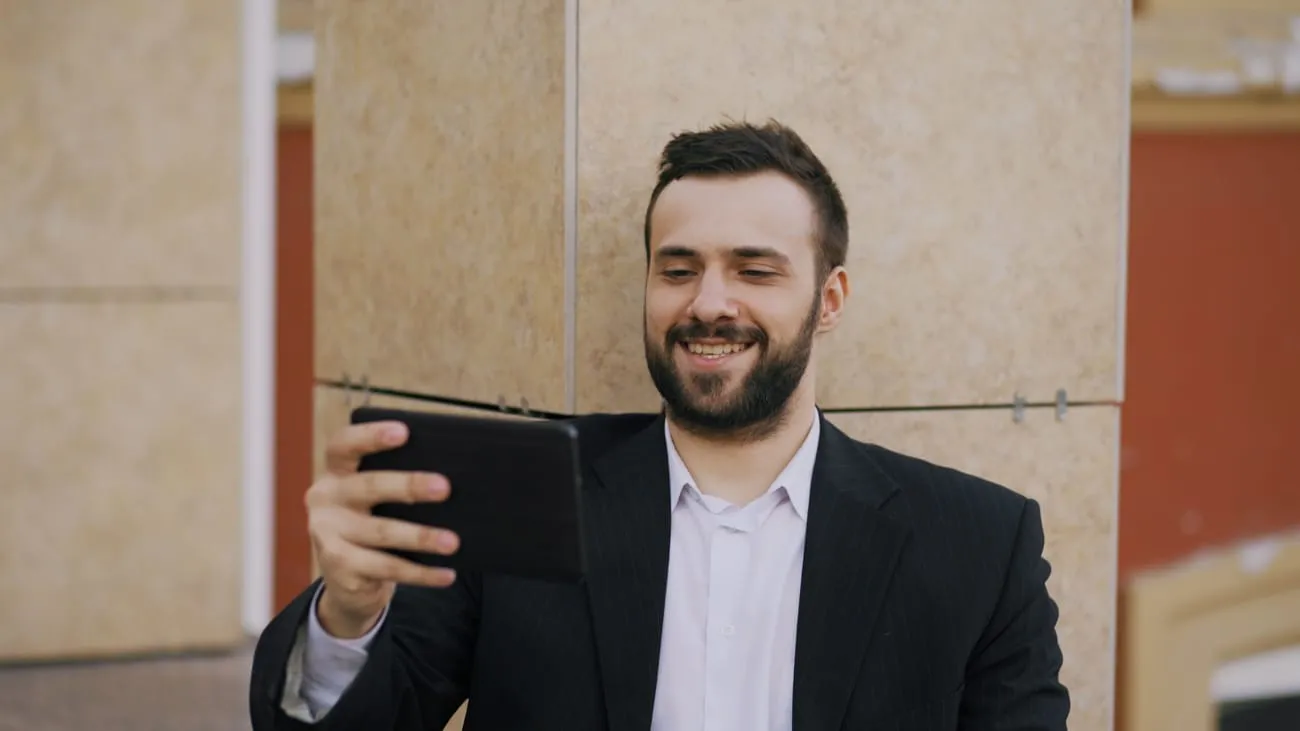 A staffing account manager checking crew status on a tablet on site.