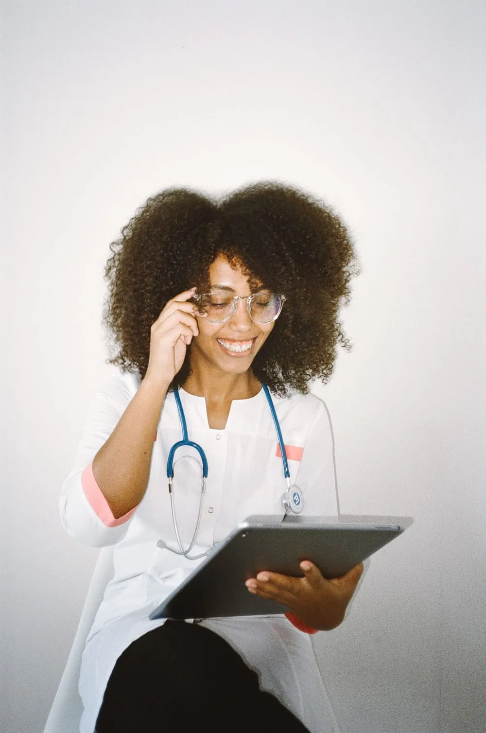 A credentialed nurse checking her next assignment on a tablet.