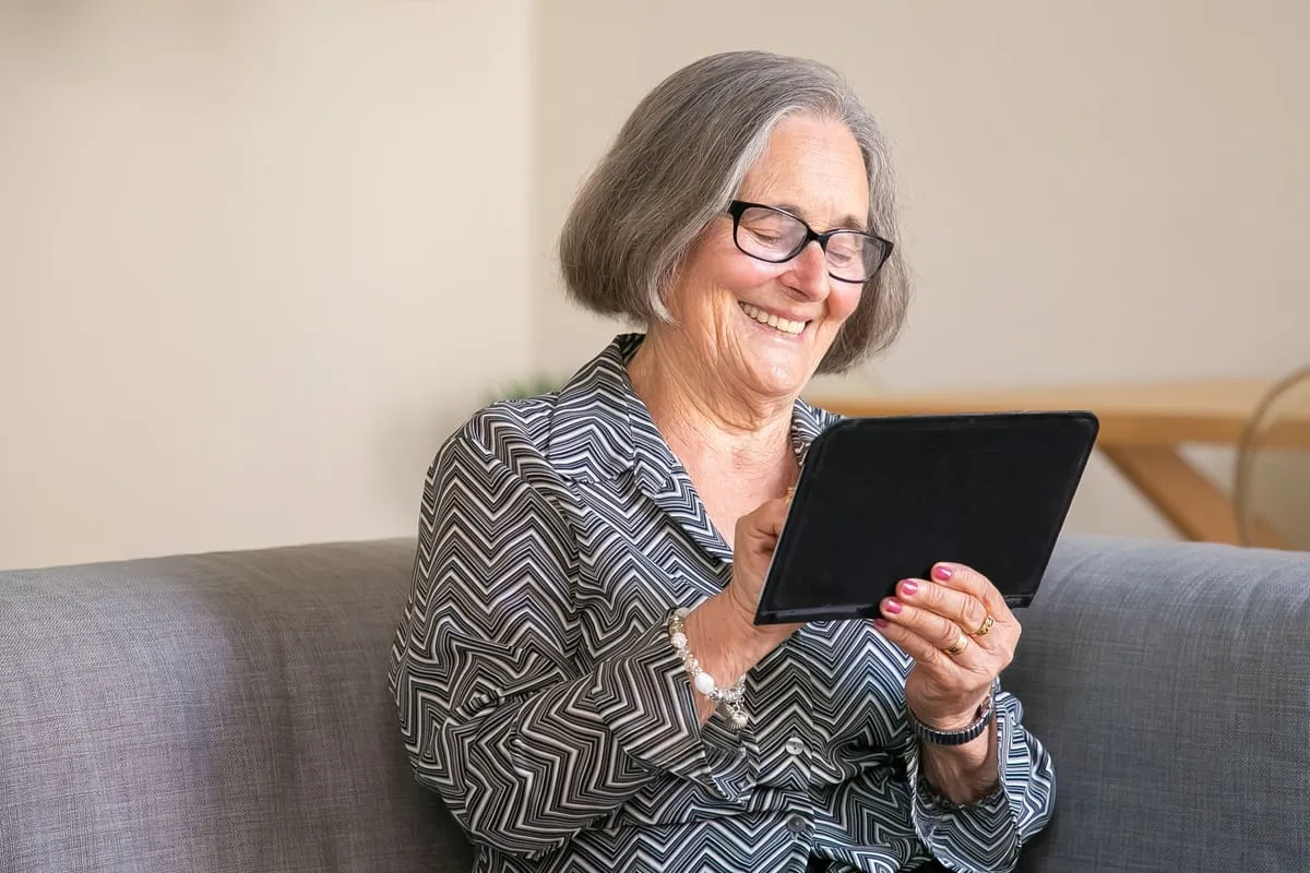A temp worker reviewing her assignment on a tablet.