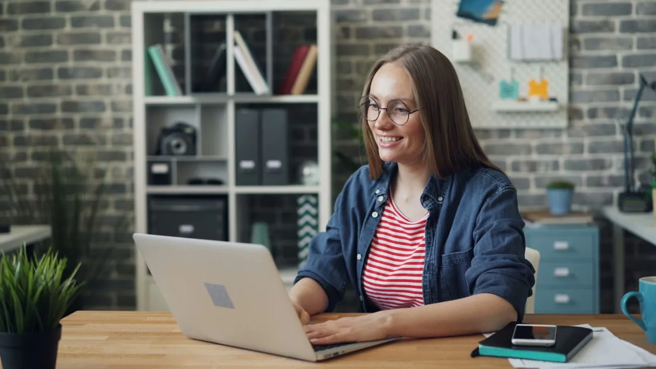 A staffing recruiter working open orders on a laptop.